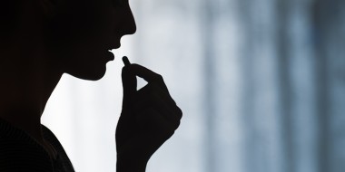 Profiel van persoon die een pil neemt.